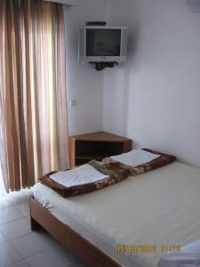 a bedroom with a bed and a tv on the wall at Apartments by the sea Prizna, Senj - 17309 in Senj