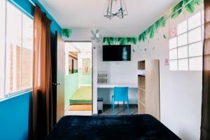 a bedroom with a bed and a room with a mirror at The Secret Garden Hostel in Lima