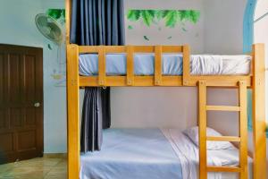 two bunk beds in a room with a door at The Secret Garden Hostel in Lima