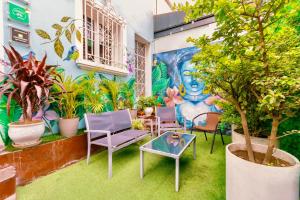 a room with chairs and a table and a mural at The Secret Garden Hostel in Lima