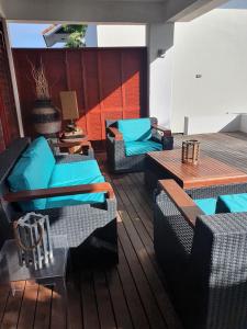 a deck with couches and tables on a boat at Hilltop Sea view , Boca Gentil in Willemstad
