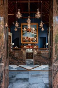 a living room with a painting on the wall at La Reserve 1785 Canggu Beach in Canggu