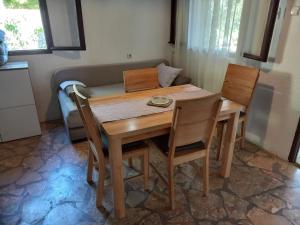 a dining room table with chairs and a couch at Holiday home Ivica - by the sea in Sevid