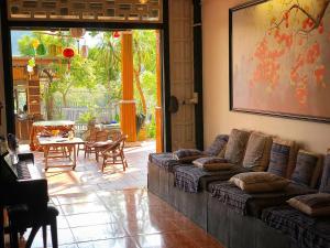 a living room with a couch and a table at Thênh Thang Home & Cafe in Mộc Châu