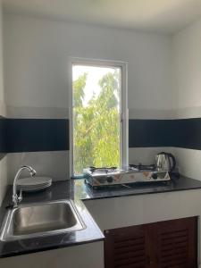 a kitchen with a sink and a window at Chaweng Residence in Chaweng