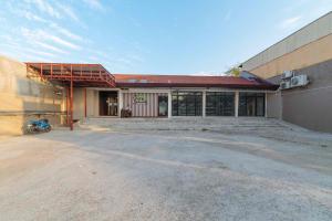 an empty building with a motorcycle parked in front of it at RedDoorz at Traveler's Inn Bajada Davao in Davao City