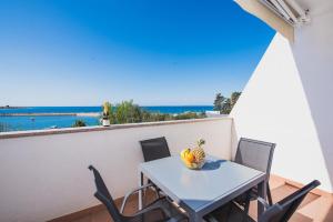 a table and chairs on a balcony with a view of the ocean at Apartments by the sea Novalja, Pag - 17214 in Novalja