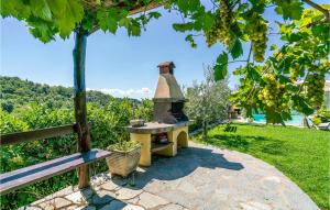 a stone pizza oven sitting next to a bench at Villamota in Arezzo