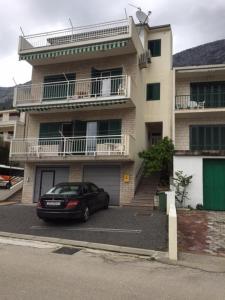 a car parked in a parking lot in front of a building at Apartments with a parking space Brela, Makarska - 17371 in Brela