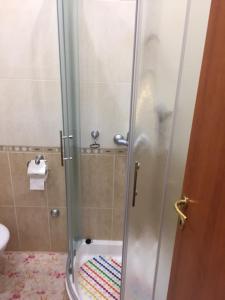 a shower with a glass door in a bathroom at Apartments with a parking space Brela, Makarska - 17371 in Brela