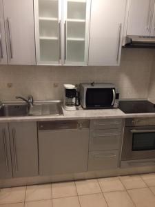 a kitchen with a sink and a microwave at Apartments with a parking space Brela, Makarska - 17371 in Brela