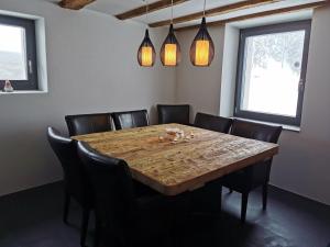 a dining room with a wooden table and chairs at Romantic standalone 5 room cottage in Valposchiavo in Poschiavo