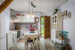 a kitchen with a table and chairs in a room at Family friendly house with a swimming pool Vojnic Sinjski, Zagora - 17375 in Trilj