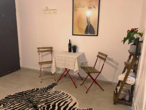 a dining room with a table and chairs and a bottle of wine at יחידה מושלמת ברמת ישי לזוג או יחיד in Ramat Yishay