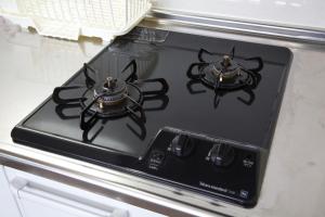a stove top with two burners on top of it at TOMMY CONDOMINIUM WAKASA 202 in Kume
