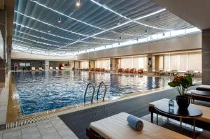 a large swimming pool in a building with a large ceiling at Crowne Plaza Beijing Zhongguancun, an IHG Hotel in Beijing