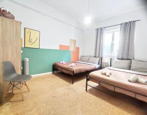 a living room with two beds and a chair at AS Monastiraki Apartment 1B in Athens