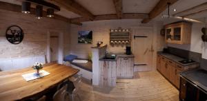 a kitchen with a wooden table in a room at Vorderkaseralm in Sankt Johann im Pongau