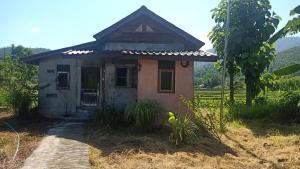 a small house in the middle of a field at Ing Doi Guest House in Pai