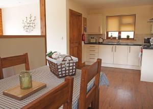 a kitchen with a table with a basket on it at Heart Of Wales Lodges in Penybont