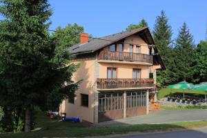 a house with a balcony on the side of it at Apartments and rooms with parking space Donje Taboriste, Plitvice - 17486 in Slunj