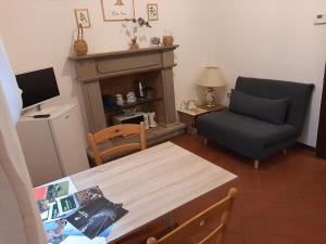 a living room with a table and a chair at La Casina della Volpe in Prato