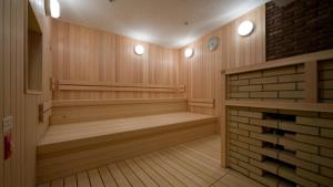 a sauna with wooden floors and a brick wall at Tokyo Bay Maihama Hotel in Urayasu