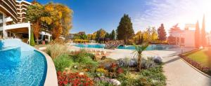 a garden with a swimming pool in a building at Flamingo Grand Hotel & Spa in Albena