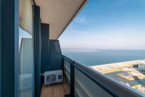 a balcony with a view of the ocean at Come a Lot Aparthotel Batumi in Batumi