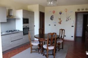 a kitchen with a table and chairs in a room at Agriturismo Sarmore in Salmore