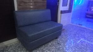 a black chair sitting in a room with blue lights at Vidya Guest House in Katra