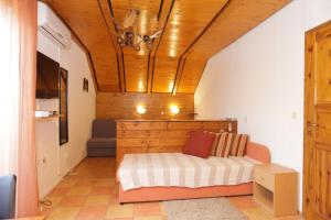 a bedroom with a bed and a wooden ceiling at Apartments and rooms with a swimming pool Grabovac, Plitvice - 17531 in Rakovica