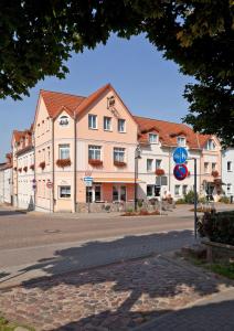 a large building on the side of a street at Hotel Für Dich in Waren