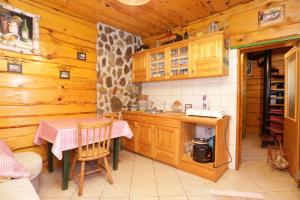 a kitchen with a table and a dining room at Apartments for families with children Perusic (Velebit) - 17540 in Perušić