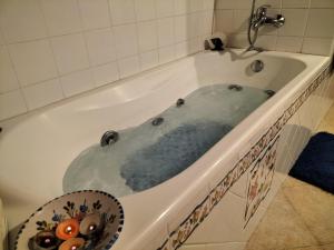 a bath tub filled with water in a bathroom at CASA BONITA in Morella