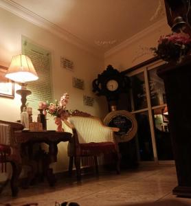 a room with a table and chairs and a clock at Hotel Posada de la Conspiración in Dolores Hidalgo +31 photos