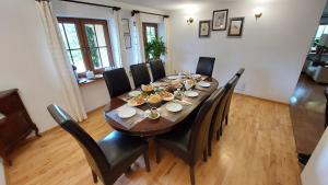 a dining room table with black chairs around it at Tulin in Wetlina