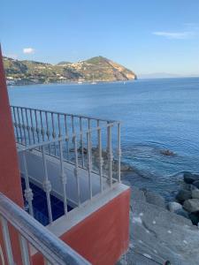 a balcony of a building overlooking the ocean at Suite Capri in Ischia