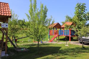a park with a playground with a play structure at Apartments for families with children Lipovac, Plitvice - 17556 in Rakovica