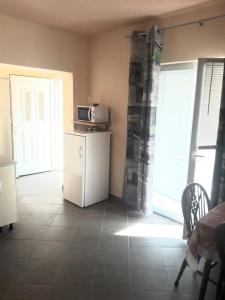 een keuken met een kleine koelkast en een magnetron bij Apartments by the sea Vrsi - Mulo, Zadar - 17066 in Vrsi