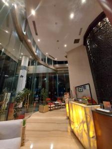 a lobby with chairs and tables in a building at Swiss-Belinn SKA Pekanbaru in Pekanbaru