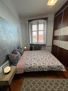 a bedroom with a large bed and a table at Jedności Hostel in Zielona Góra +3 photos