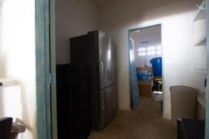 a kitchen with a stainless steel refrigerator in a room at Cabaña CasaMare in Rincón