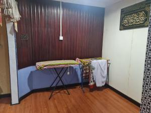 a room with a table and a wall at AnNur Homestay in Lahad Datu