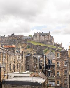 a view of a city with a castle in the background at Amazing Castle View Apartment in Edinburgh