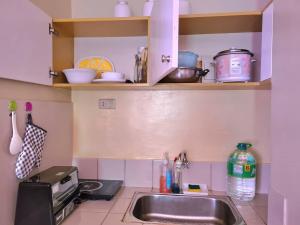 a kitchen with a sink and a counter top at Pet Friendly Transient along Ortigas Ext in Cainta