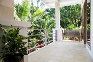 a porch with a view of trees and plants at CASA MIMBA - Seaview Private Pool Villa Padangbai in Padangbai