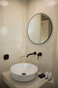 a bathroom with a sink and a mirror at Olive Villa in Kamari