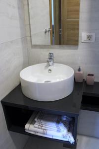 a white sink on a black counter in a bathroom at Apartment Zrnovska Banja 17457b in Korčula