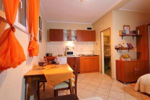 a kitchen with a table and a small kitchen with a tableablish at Apartments by the sea Lopud, Elafiti - 17200 in Lopud